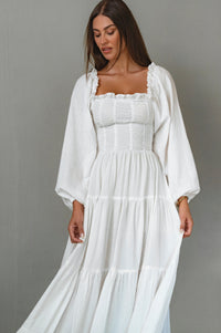 Woman wearing a white dress with a plain background cottage core style