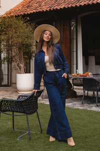 Model in a stylish outfit with a wide-brimmed hat standing outdoors - cottage core style